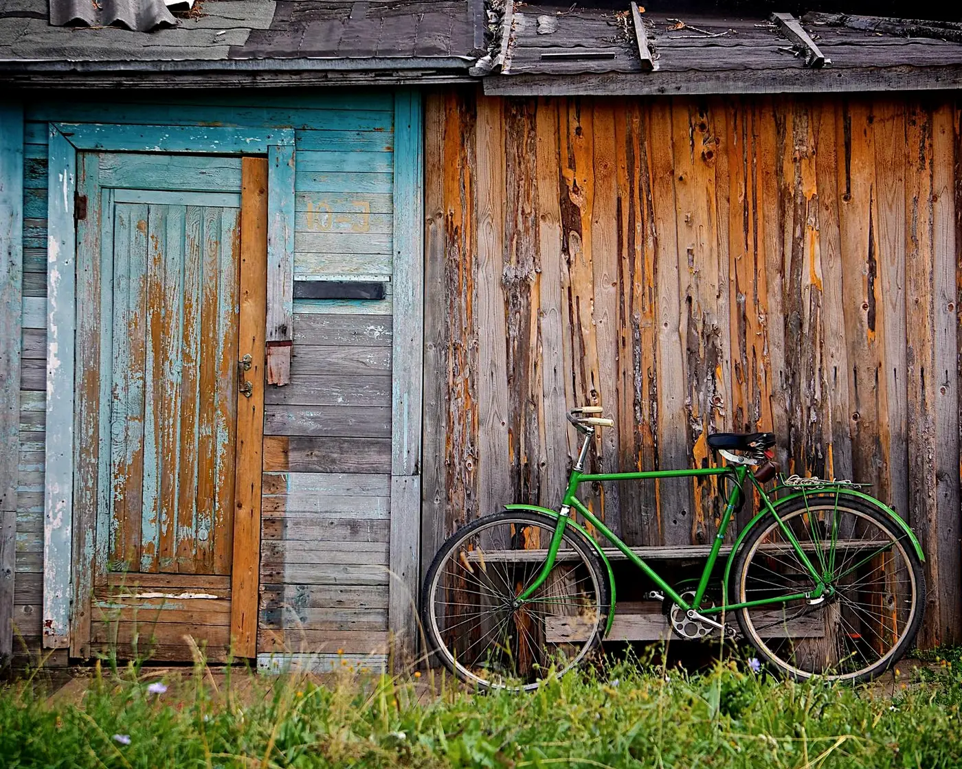A rustic wooden holiday cabin with a bicycle leaning outside